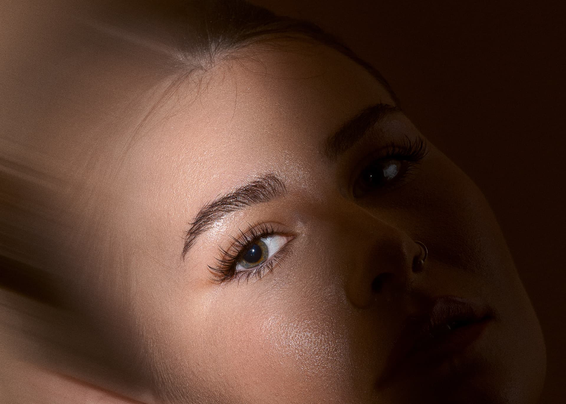 Dramatic lash close-up with warm studio lighting